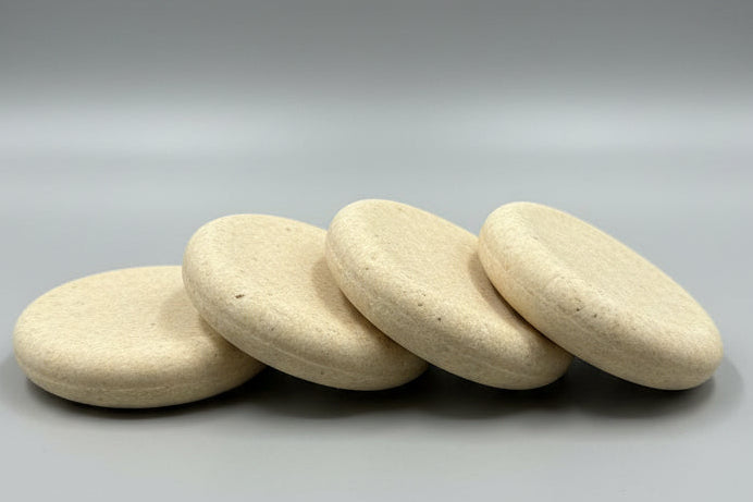 Stack of soap bar on a wooden board with a blurred background