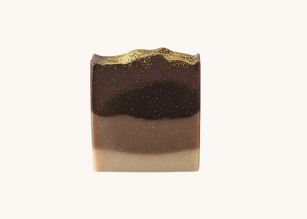 Creation Essential's Natural Body Frankincense & Myrrh honey bar soap with a dark brown gradient and gold shimmer top.