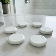 Green rounf soap bar on the counter 
