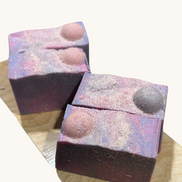 Creation Essential's Natural Body Moon Light salty soap bars with purple and pink swirls and Himalayan salt topping.