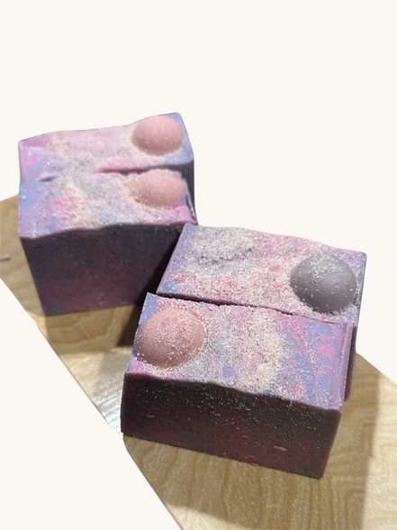 Creation Essential's Natural Body Moon Light salty soap bars with purple and pink swirls and Himalayan salt topping.