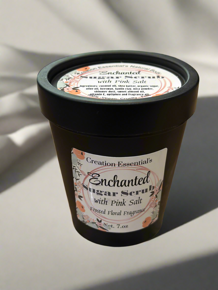 Container of Enchanted Sugar Scrub with Pink Salt on a light background