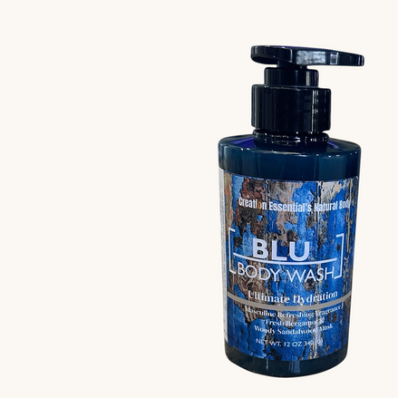 Creation Essential's Natural Body BLU organic body wash in a pump bottle with a rustic blue wood grain label design.