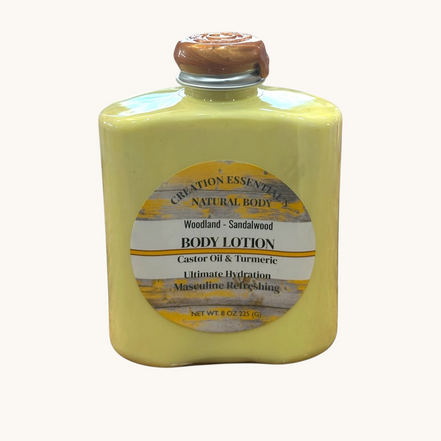 Creation Essential's Natural Body Woodland Sandalwood men's body lotion in a yellow bottle with a wax-sealed cap.