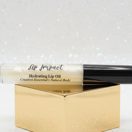 Lip impact hydrating lip oil with black cap on a white background
