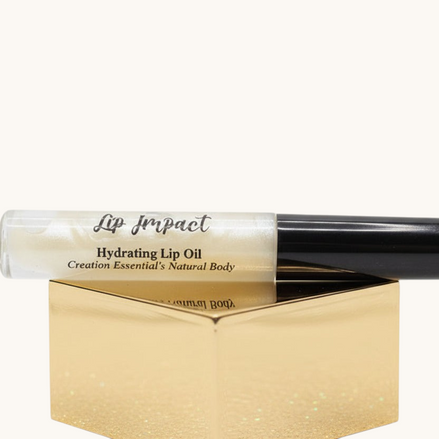 Lip impact hydrating lip oil with black cap on a white background