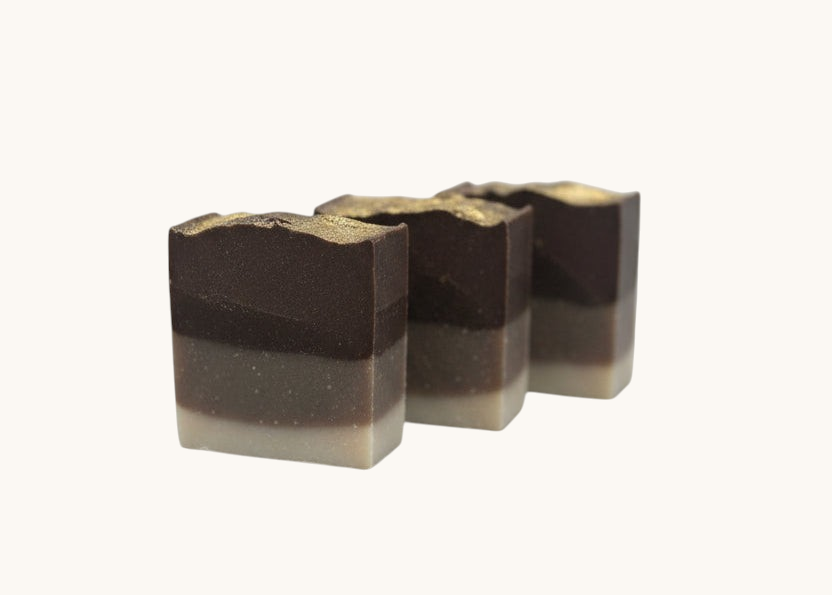 Creation Essential's Natural Body Frankincense and Myrrh honey bar soap with a layered brown design and gold top