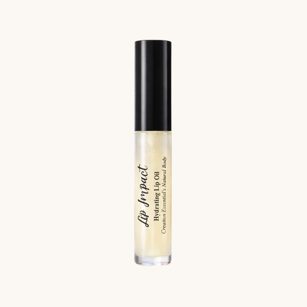 Creation Essential's Natural Body Lip Impact Hydrating Lip Oil in a clear tube with black cap, set among cherry blossoms