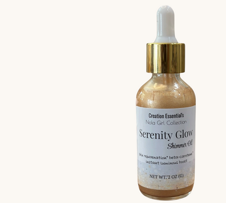 Creation Essential's Natural Body Serenity Glow shimmer oil in a glass dropper bottle with gold cap on wooden surface