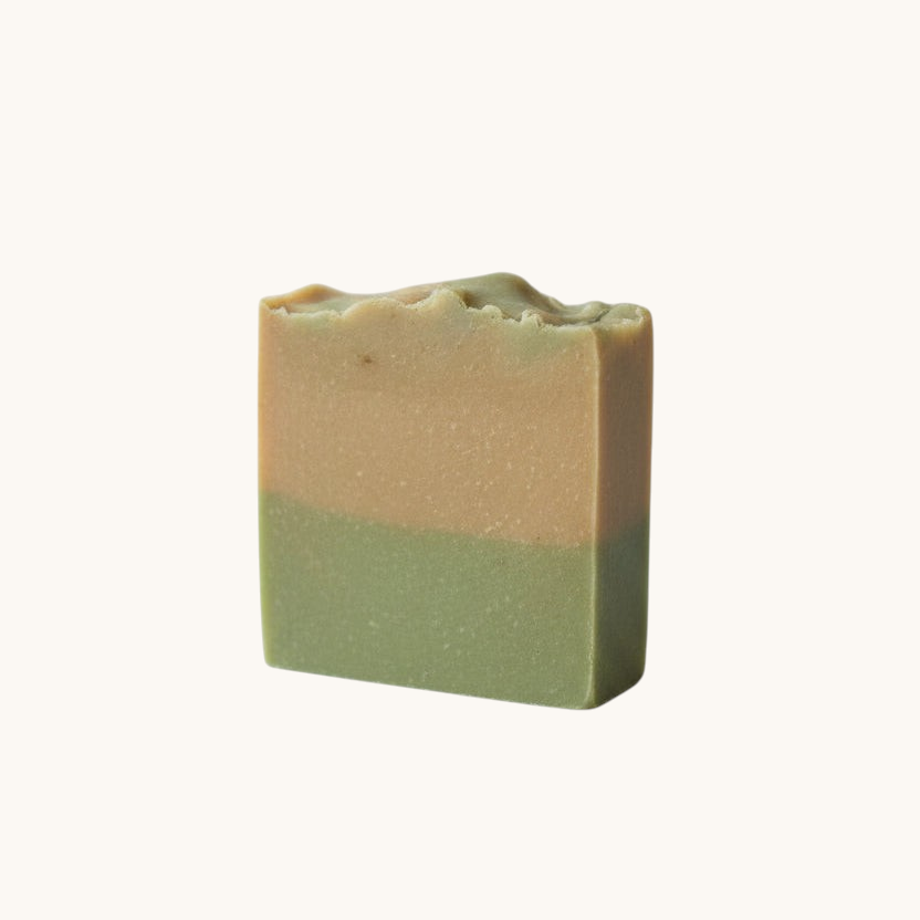Creation Essential's Natural Body cucumber and melon hydration soap bar with a two-tone green and tan layered design.