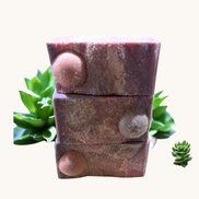 Creation Essential's Natural Body Moon Light salty soap bars stacked with textured mahogany finish and salt crystals
