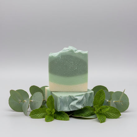 Stack of green and white striped soap bars 
