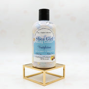 Bottle of Shea Girl body lotion on a gold surface
