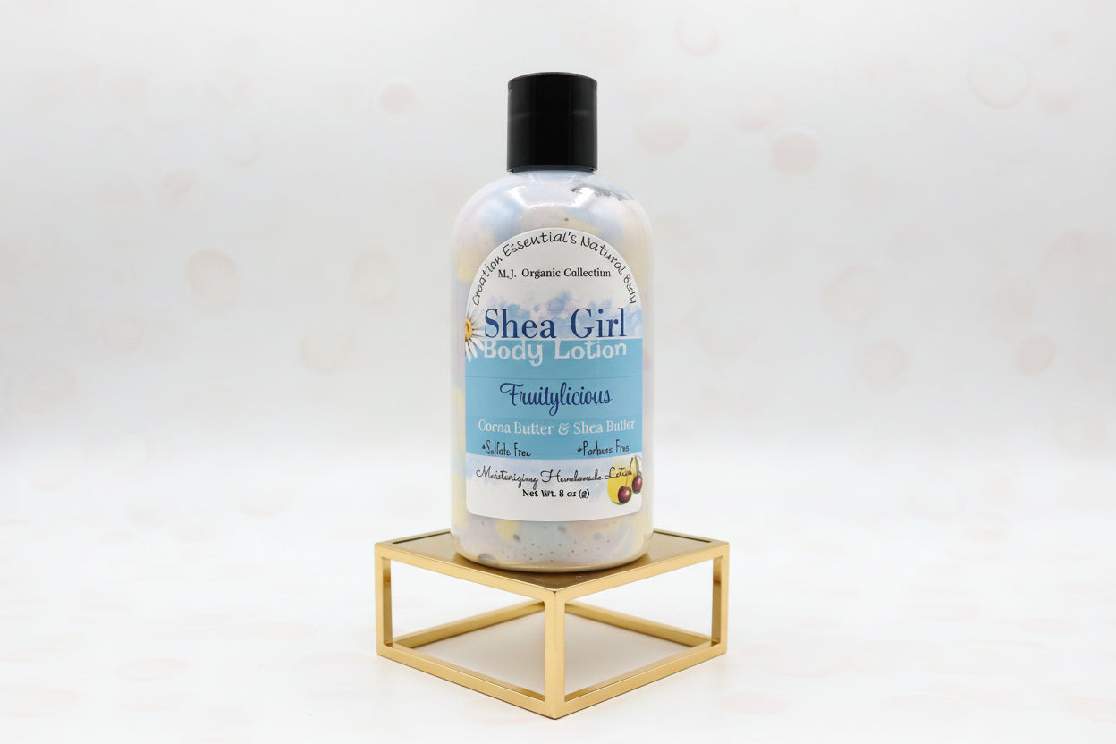 Bottle of Shea Girl body lotion on a gold surface