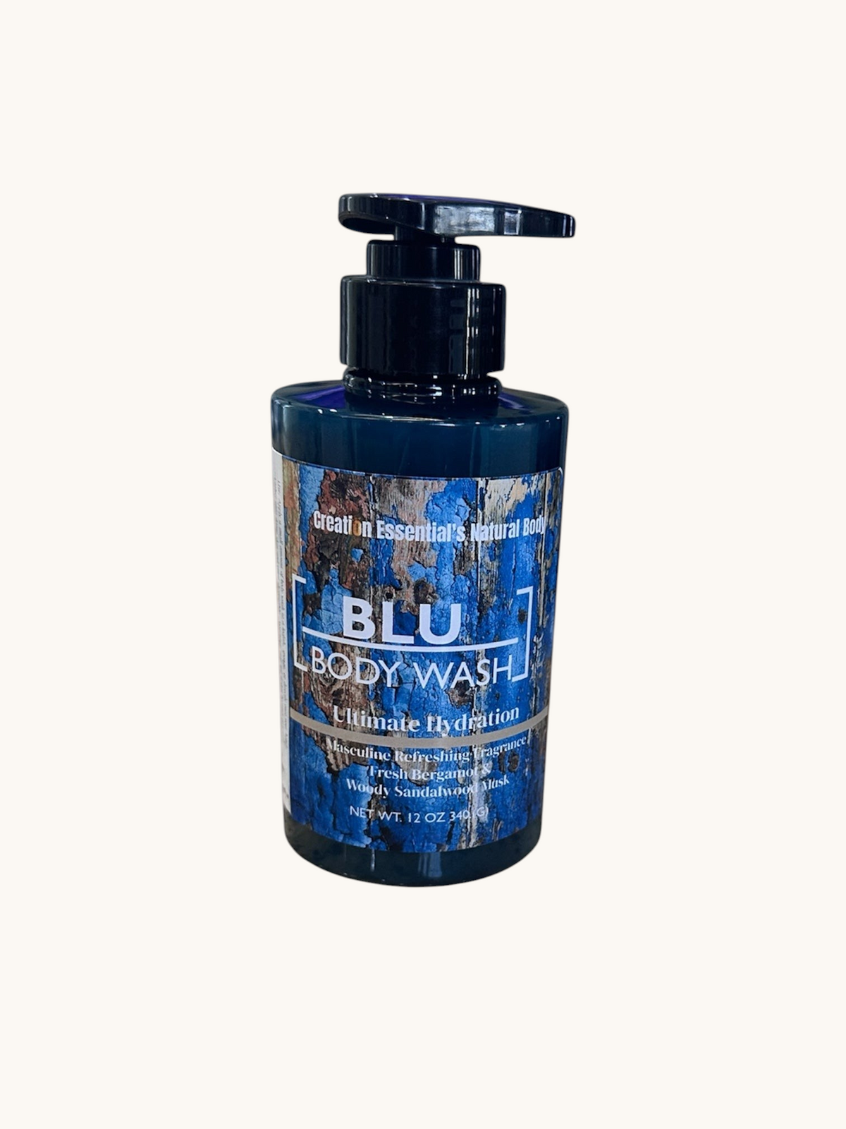Creation Essential's Natural Body BLU organic masculine body wash in a 12oz pump bottle on a wooden surface