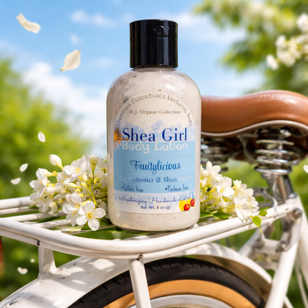 Shea Girl body lotion bottle on a bicycle seat with flowers and a natural background