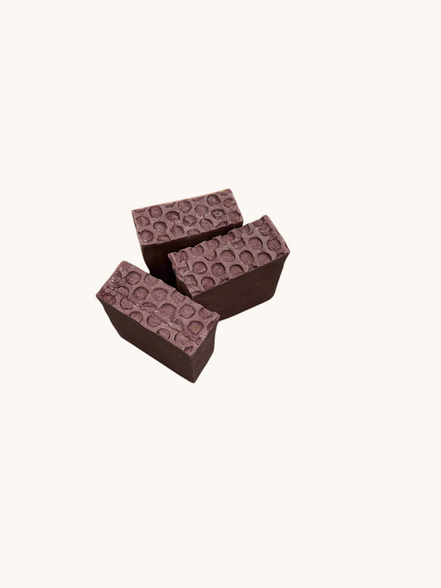 Creation Essential's Natural Body Sweet Harvest bar soap with a textured honeycomb top on a light green background.