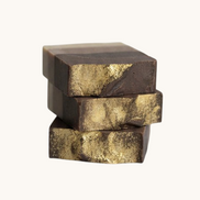 Creation Essential's Natural Body frankincense and myrrh honey bar soap with gold mica shimmer stacked on white