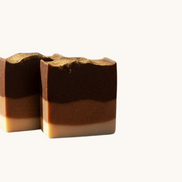 Creation Essential's Natural Body Frankincense & Myrrh honey bar soap with three-toned layers and gold mica dusting.