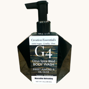 Creation Essential's Natural Body G4 citrus spice wood body wash in a black geometric pump bottle on a marble surface.