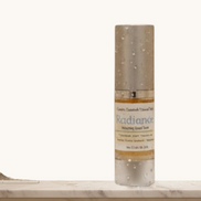 Creation Essential's Natural Body Radiance Hyaluronic Facial Toner bottle on a marble ledge in a steamy shower.