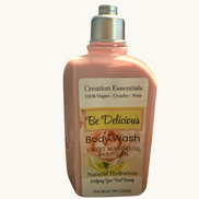 Creation Essential's Natural Body Be Delicious body wash in a pink bottle with sweet almond and olive oil ingredients.