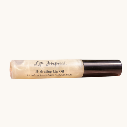 Creation Essential's Natural Body Lip Impact hydrating lip oil in a clear tube resting on a polished stone surface.