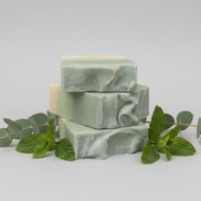 Green soap bar on  eucalyptus and spearmint leaves