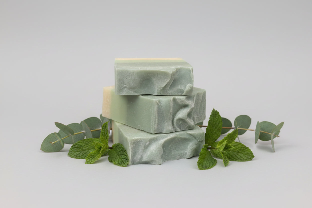 Green soap bar on  eucalyptus and spearmint leaves