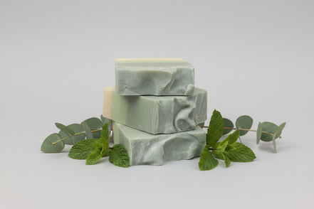 Green soap bar on  eucalyptus and spearmint leaves