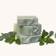 Green soap bar on  eucalyptus and spearmint leaves