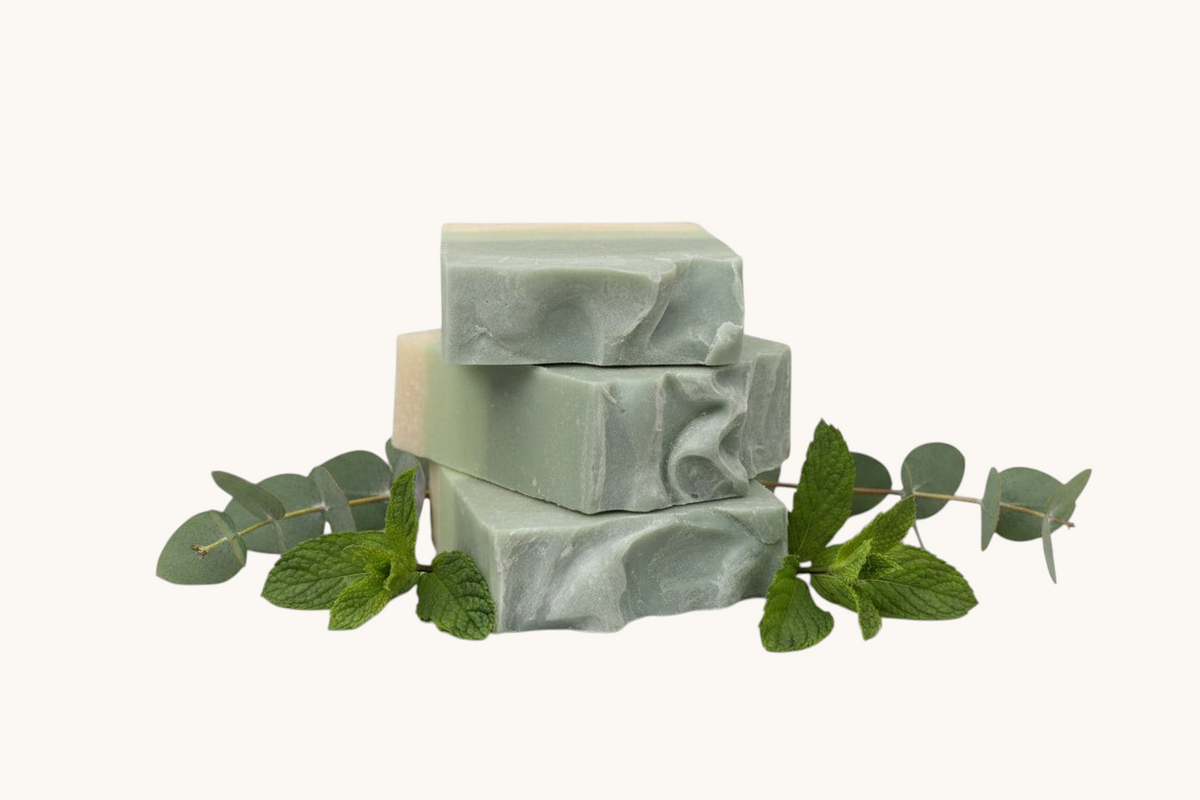 Green soap bar on  eucalyptus and spearmint leaves