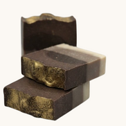 Creation Essential's Natural Body Frankincense and Myrrh honey bar soap with gold mica swirl and layered brown tones.