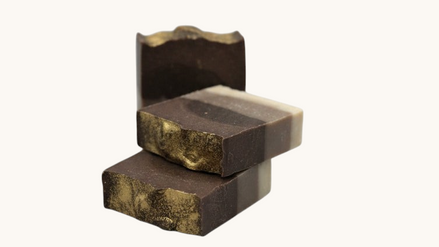 Creation Essential's Natural Body Frankincense and Myrrh honey bar soap with gold mica swirl and layered brown tones.