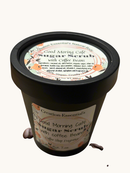 Creation Essential's Natural Body Good Morning Cafe creamy coffee bean sugar scrub in a black jar with scattered beans