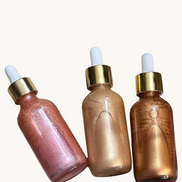 Creation Essential's Natural Body three-pack shimmer oil set in glass dropper bottles with gold lids