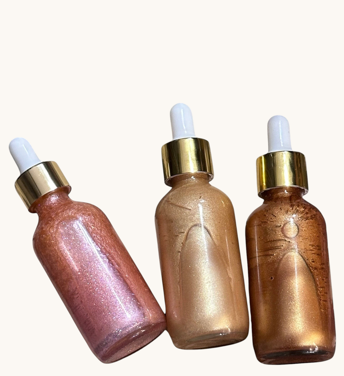 Creation Essential's Natural Body three-pack shimmer oil set in glass dropper bottles with gold lids