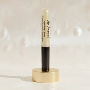 Lip balm with black cap and visible brand name on a white background
