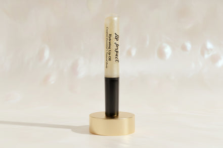 Lip balm with black cap and visible brand name on a white background