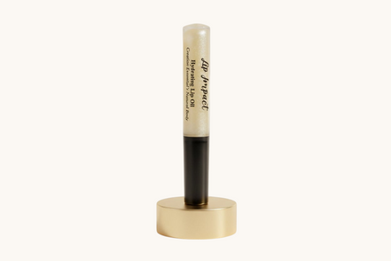 Lip balm with black cap and visible brand name on a white background