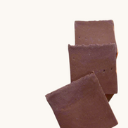 Creation Essential's Natural Body Sweet Harvest bar soap with red clay, featuring a natural leaf and nut accent.