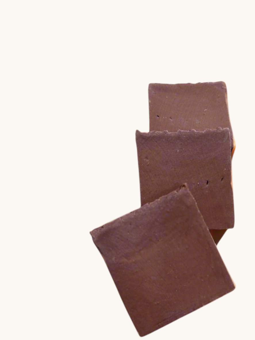 Creation Essential's Natural Body Sweet Harvest bar soap with red clay, featuring a natural leaf and nut accent.