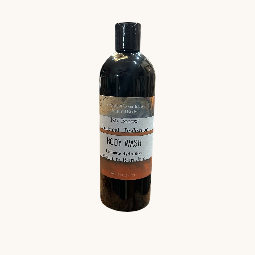 Creation Essential's Natural Body Bay Breeze Tropical Teakwood organic body wash in a 16oz black bottle.