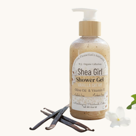 Shea Girl Shower Gel bottle on a wooden surface with vanilla beans and flowers in the background