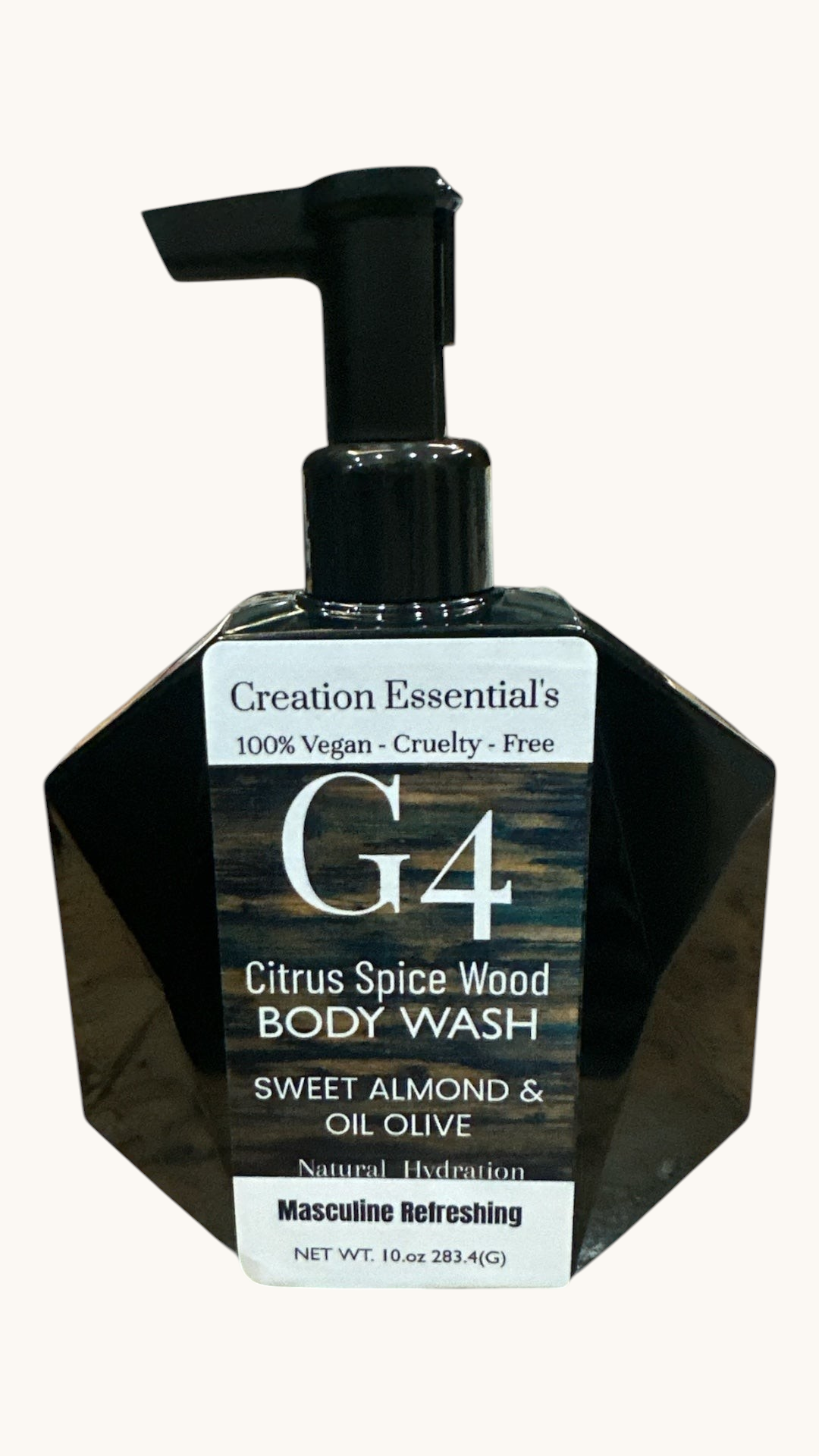 Creation Essential's Natural Body G4 body wash in a black geometric pump bottle with citrus spice wood fragrance