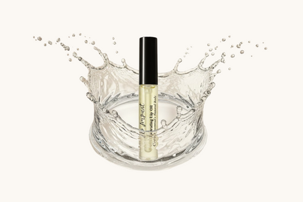 Cosmetic bottle with water splash on a beige background