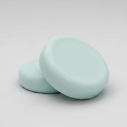  round soap bars  on a textured brown surface