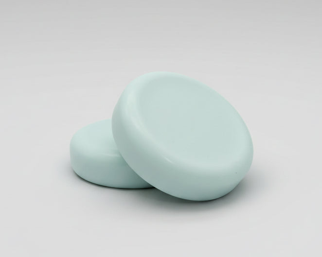  round soap bars  on a textured brown surface