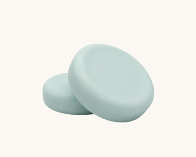 round soap bars  on a textured brown surface