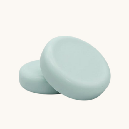 round soap bars  on a textured brown surface